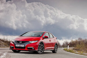 "Ogulin, Croatia - April 7th, 2012: New Honda Civic parked on the road near Bjelolasica mountain with heavy clouds watching over."